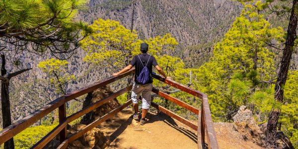 A young tourist enjoying the view of Cumbrecita mountains in Caldera de Taburiente national park